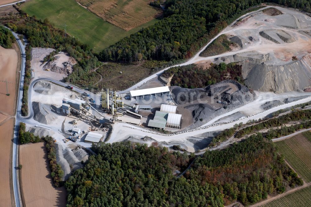 Gössenheim from above - Grounds and overburden surfaces open pit mining and building material works of the companies Kalkstein-Schottertwerk Goessenheim GmbH & Co. KG and AMS Asphaltmischwerke Main-Saale GmbH + Co. KG in Goessenheim in the state Bavaria, Germany