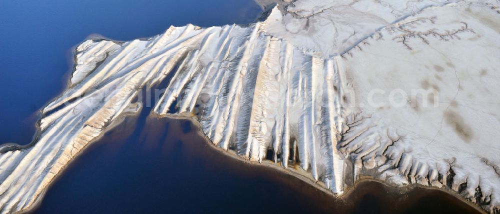 Bluno from above - Tagebaulandschaft mit Abraumhalden am Blunoer Südsee (obersorbisch Juzny Blunjanski jezor) ist ein Tagebaurestsee der Lausitzer Seenkette im sächsischen Teil des Lausitzer Seenlandes, auf dem Gebiet der Gemeinde Elsterheide. Seinen Namen verdankt der See einerseits seiner Lage südlich des Ortes Bluno. Der See entstand durch Flutung des Restlochs „ Nordschlauch “ des Tagebaues Spreetal. Lusatian lake district in the Saxon part of the Lusatian Lake District.