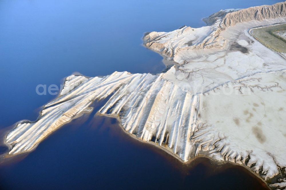 Bluno from the bird's eye view: Tagebaulandschaft mit Abraumhalden am Blunoer Südsee (obersorbisch Juzny Blunjanski jezor) ist ein Tagebaurestsee der Lausitzer Seenkette im sächsischen Teil des Lausitzer Seenlandes, auf dem Gebiet der Gemeinde Elsterheide. Seinen Namen verdankt der See einerseits seiner Lage südlich des Ortes Bluno. Der See entstand durch Flutung des Restlochs „ Nordschlauch “ des Tagebaues Spreetal. Lusatian lake district in the Saxon part of the Lusatian Lake District.