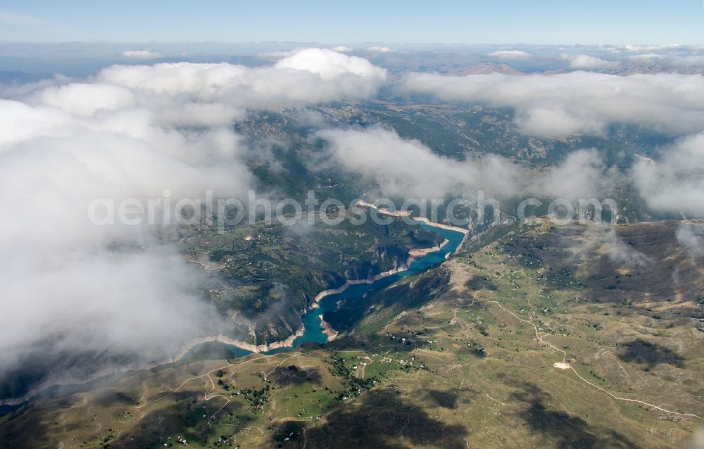 Aerial image Plužine - Dam and shore areas at the lake in Plužine in Montenegro. The Pivsko Lake is a reservoir in northwestern of Montenegro and is the largest dam in the country. The reservoir flooded the original site of the Piva monastery