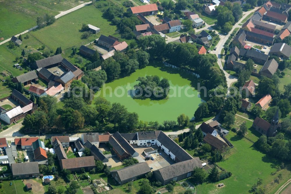 Aerial image Borgisdorf - Pond in the centre of the village of Borgisdorf in the state of Brandenburg. The pond with its small island is located in the centre of the village in the county district of Teltow-Flaeming