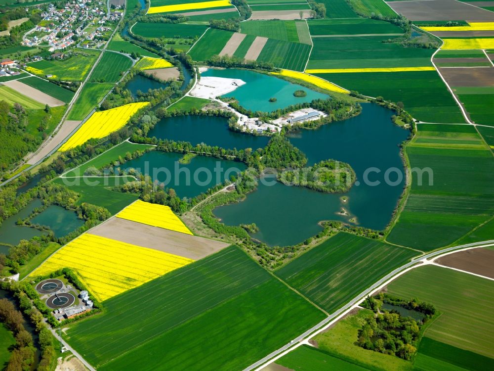 Rottenacker from the bird's eye view: Ponds and quarry lakes in Rottenacker in the state of Baden-Wuerttemberg. The ponds are located on the riverbank of the Danube, surrounded by fields and agricultural spaces. They are located in the North of the borough and are also used for leisure and swimming