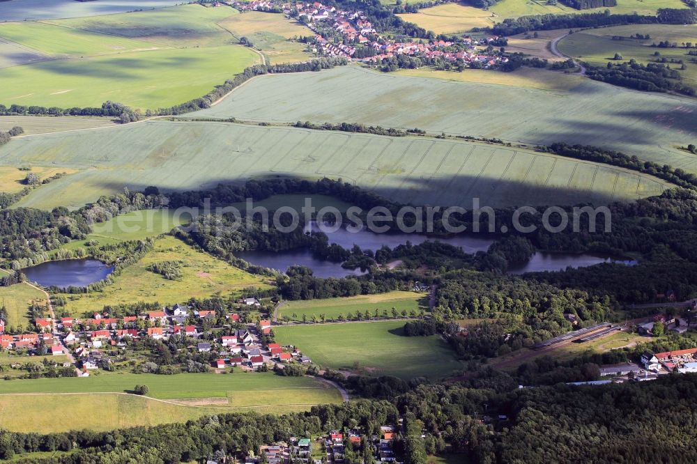 Herrenhof from the bird's eye view: Between Georgenthal and Herrenhof in Thuringia are three ponds, which are caused by flooded gravel pits. These habitats with excellent water quality are used as fishing ponds. In the foreground of the railway station of Georgenthal can be seen