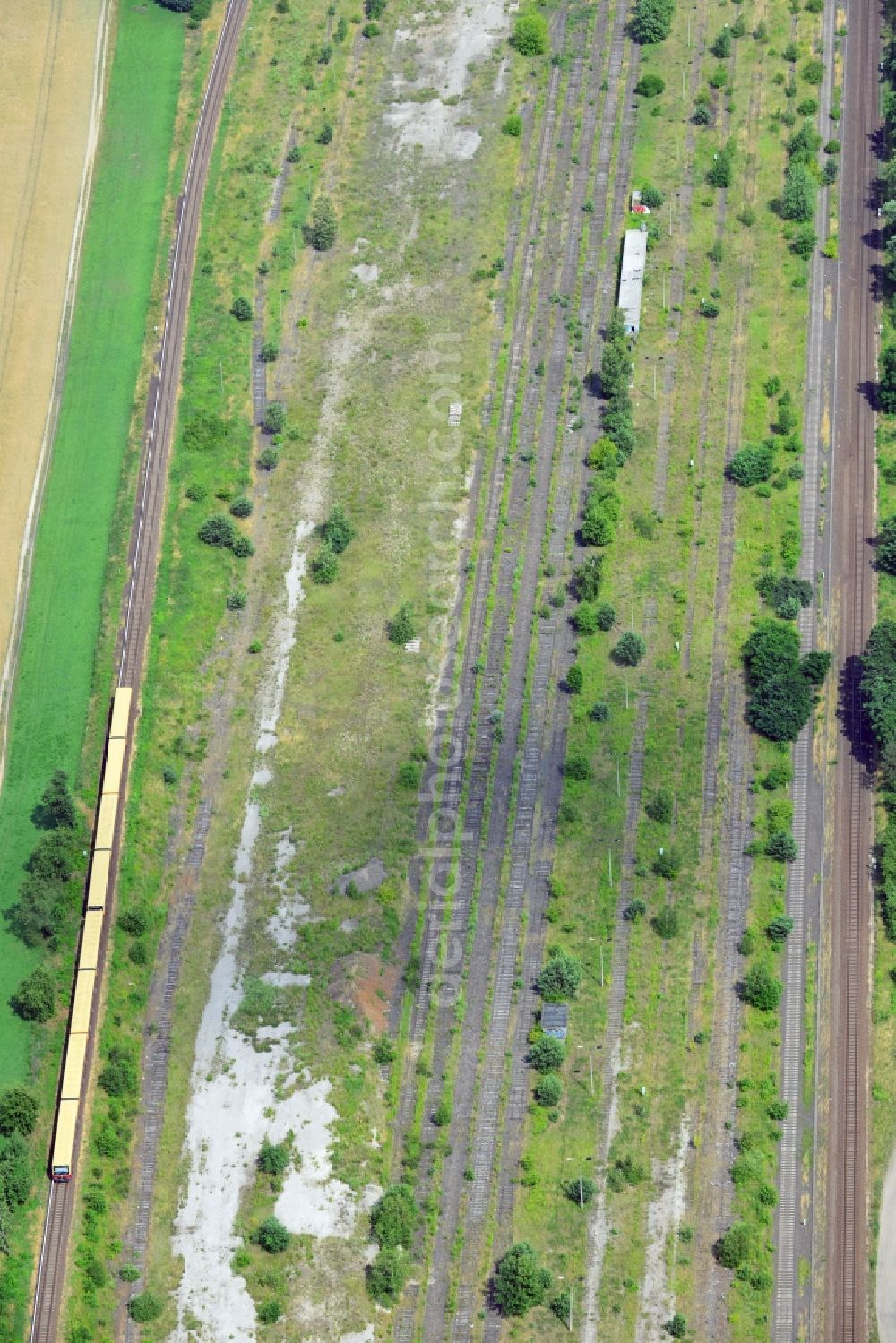 NEUENHAGEN from above - Parts of the railway road between Neuenhagen and Fredersdorf close to Berlin in the state of Brandenburg. Parts of the railroad tracks belong to the S-Bahn (fast train) and freight railroad system. Inbetween some parts of the railroad are disused