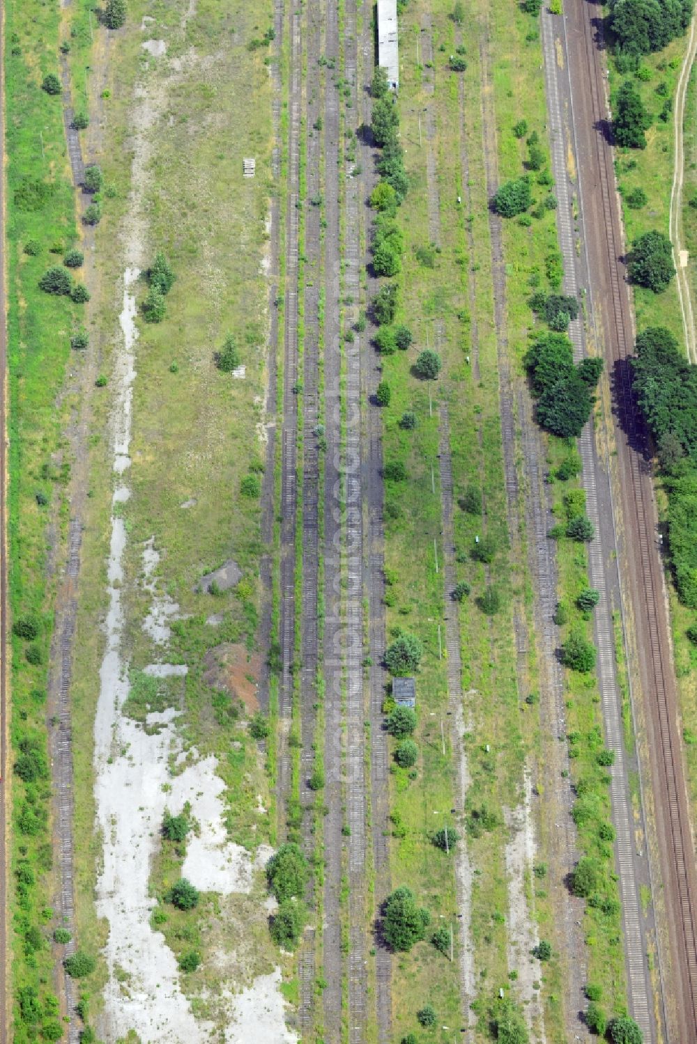 NEUENHAGEN from the bird's eye view: Parts of the railway road between Neuenhagen and Fredersdorf close to Berlin in the state of Brandenburg. Parts of the railroad tracks belong to the S-Bahn (fast train) and freight railroad system. Inbetween some parts of the railroad are disused