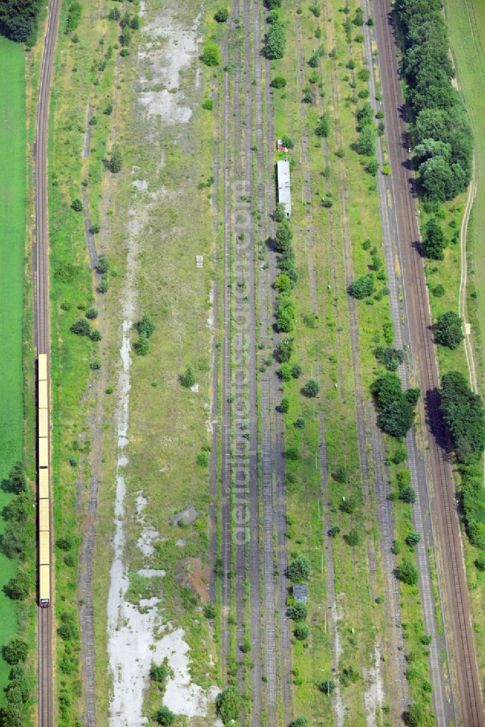 Aerial image NEUENHAGEN - Parts of the railway road between Neuenhagen and Fredersdorf close to Berlin in the state of Brandenburg. Parts of the railroad tracks belong to the S-Bahn (fast train) and freight railroad system. Inbetween some parts of the railroad are disused