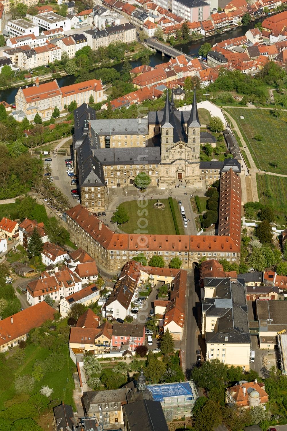 Bamberg from above - View of the monastery Michelsberg in Bamberg in Bavaria. The Michel Monastery mountain, which is also called Michael and was founded in 1015, is a former Benedictine monastery in the diocese of Bamberg. After its dissolution in 1803, the premises of the nursing home United Catherine and Elizabeth Hospital moved there