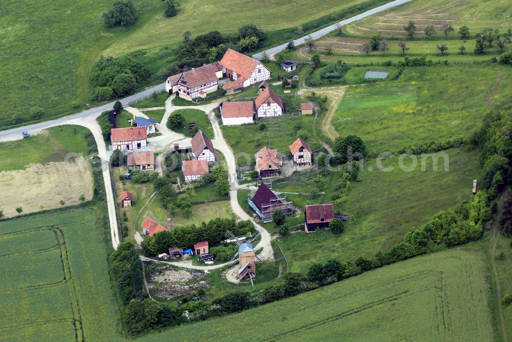 Hohenfelden from above - The Thuringian open air museum Hohenfelden in the state of Thuringia is an artificially created village in the rural and rural buildings in different regions of Thuringia are presented. In this picture the building ensemble is to see Am Eichenberg, consisting of farm buildings and a windmill