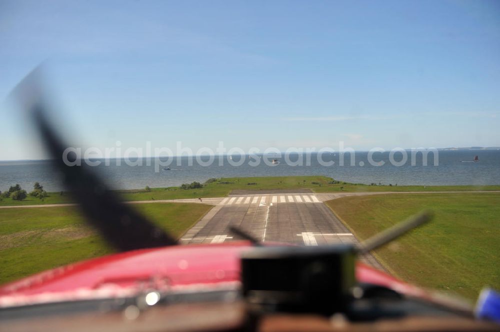 Peenemünde from the bird's eye view: Blick über das Cockpit einer Cessna 172 während eines tiefen Überflugs auf dem Flugplatz Peenemünde EDCP in Richtung Ostsee in Mecklenburg-Vorpommern. View over the cockpit of a Cessna 172 during a low approach at the Peenemünde airfield in the direction to the Baltic sea in Mecklenburg-Western Pomerania.