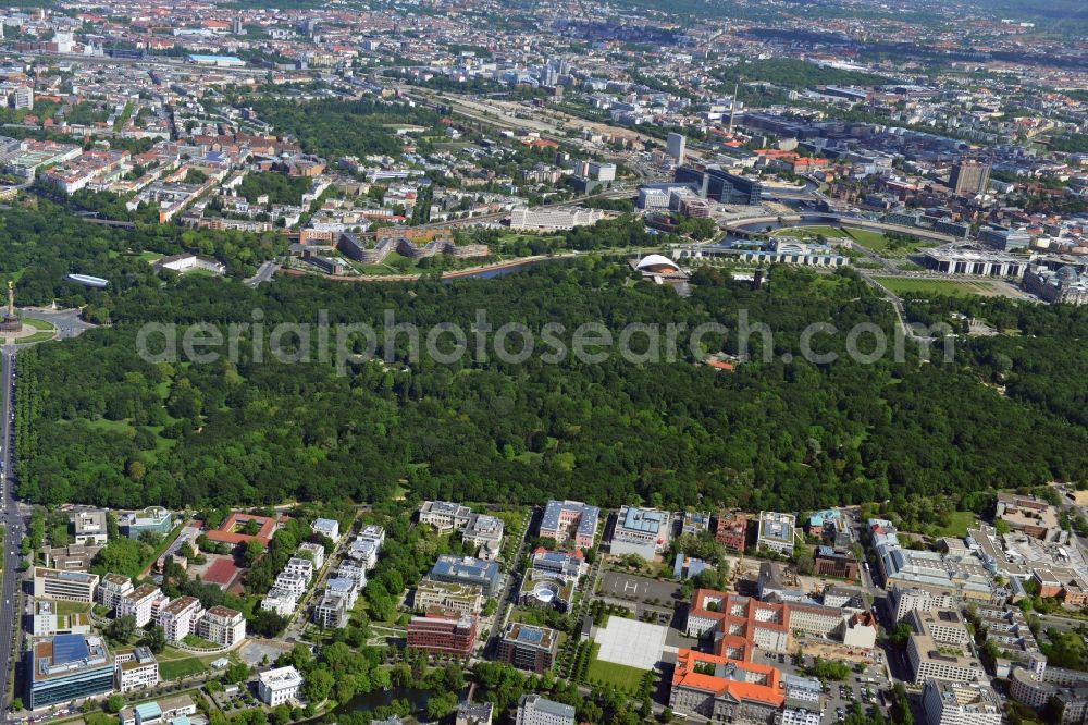 Aerial image Berlin - As a large central park, the Tiergarten is located in the homonymous district of Berlin. Dividing the green area of ??the Straße des 17 June the Victory Column stands at the western end. Striking is the House of World Cultures. The Pregnant Oyster also called building was built as part of the international building exhibition. North of the Tiergarten, the buildings on the government district close to the Chancellery and the Reichstag building. Not far from the Spree the main train station and the high-rise building of the University Hospital Charité are to recognize . At the Tiergartenstraße a number of embassies have their headquarters, the Turkish Embassy, the Italian Embassy and the Japanese Embassy