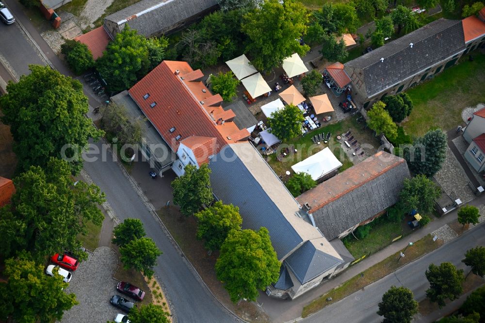 Petershagen/Eggersdorf from above - Tables and benches of open-air restaurants Madels on Dorfstrasse in Petershagen/Eggersdorf in the state Brandenburg, Germany