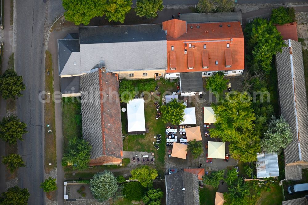 Petershagen/Eggersdorf from above - Tables and benches of open-air restaurants Madels on Dorfstrasse in Petershagen/Eggersdorf in the state Brandenburg, Germany