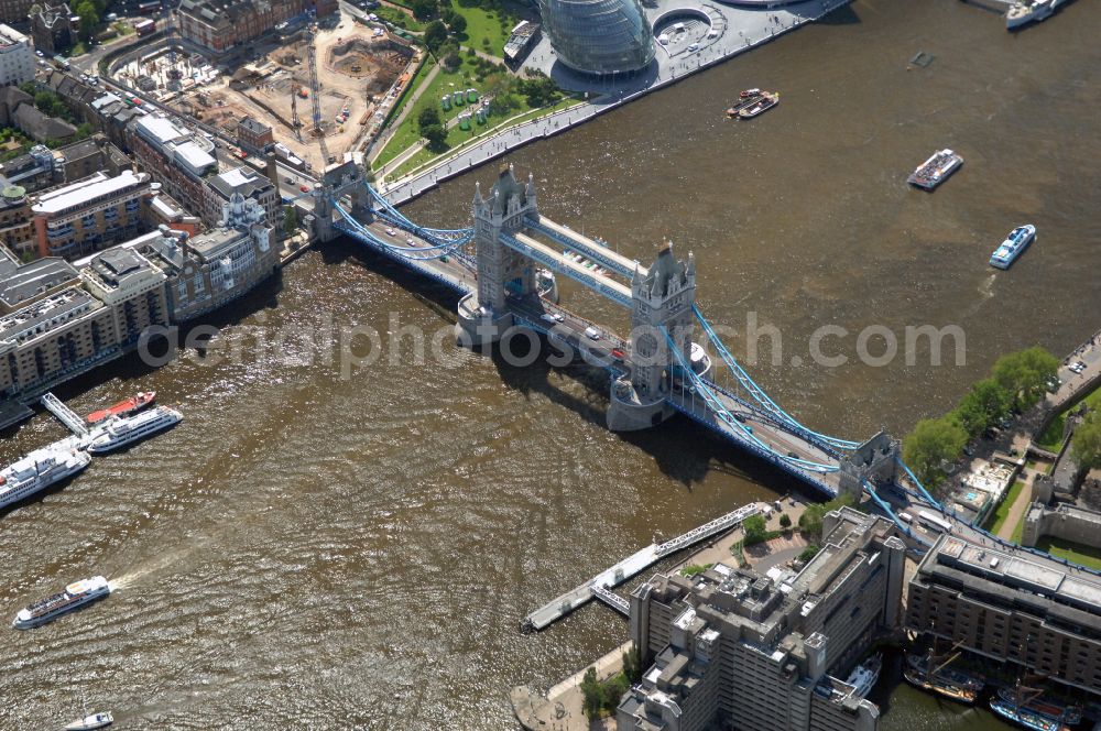 Aerial image London - River - bridge structure and landmark of the Victorian bascule and suspension bridge Tower Bridge for crossing the river Thames on Tower Bridge Rd in London in England, United Kingdom