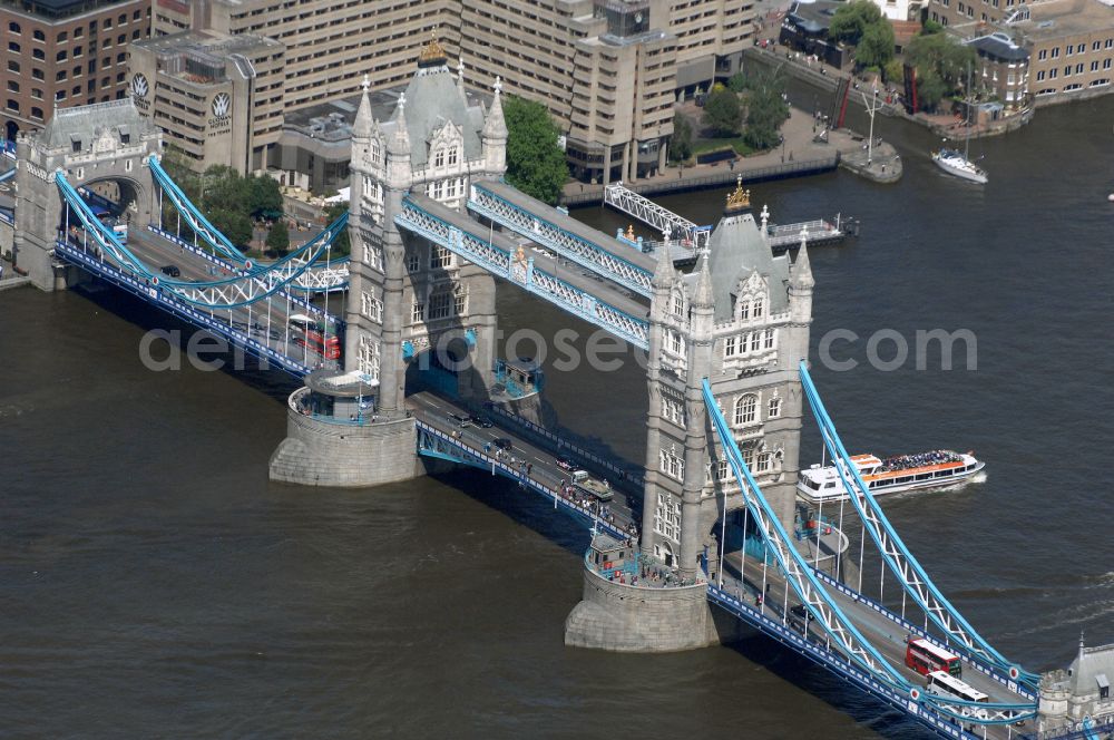 Aerial image London - River - bridge structure and landmark of the Victorian bascule and suspension bridge Tower Bridge for crossing the river Thames on Tower Bridge Rd in London in England, United Kingdom