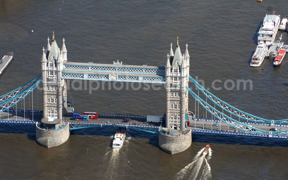 Aerial image London - River - bridge structure and landmark of the Victorian bascule and suspension bridge Tower Bridge for crossing the river Thames on Tower Bridge Rd in London in England, United Kingdom