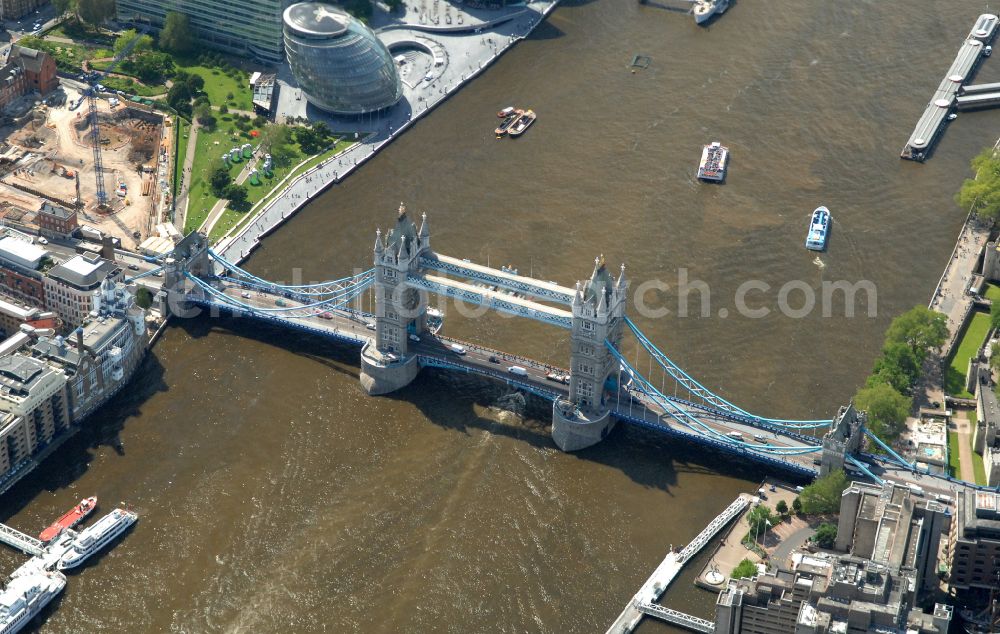 Aerial image London - River - bridge structure and landmark of the Victorian bascule and suspension bridge Tower Bridge for crossing the river Thames on Tower Bridge Rd in London in England, United Kingdom