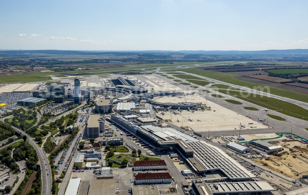 Wien from the bird's eye view: Tower, runway, terminal and taxiways of the airport Vienna Schwechat in Austria