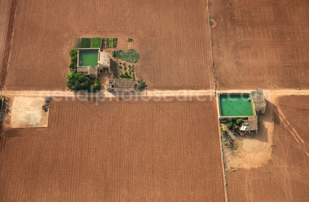 Manacor from above - Traditional water - reservoir on the fields of Mallorca at Manacor in Balearic Islands, Spain