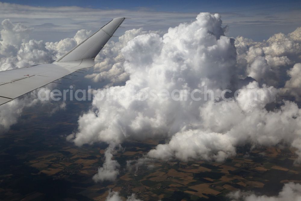 Aerial photograph Odelzhausen - The wing of an airliner Bombardier CRJ900 of Lufthansa CityLine in flight above the clouds in the area of Odelzhausen in the state of Bavaria