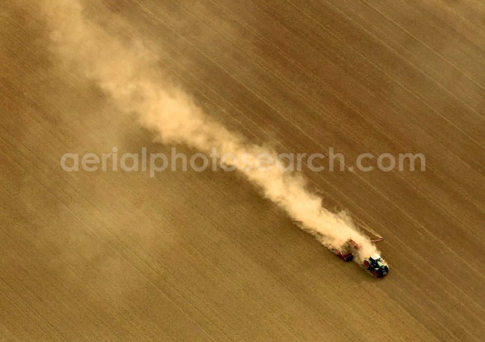 Deuna from above - Tractor at harvest on a field at Deuna in Thuringia