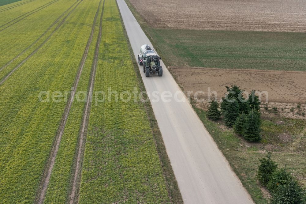 Bietigheim-Bissingen from the bird's eye view: Harvest use of heavy agricultural machinery - combine harvesters and harvesting vehicles on agricultural fields in Bietigheim-Bissingen im Bundesland Baden-Wuerttemberg