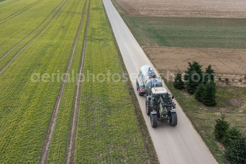 Aerial image Bietigheim-Bissingen - Harvest use of heavy agricultural machinery - combine harvesters and harvesting vehicles on agricultural fields in Bietigheim-Bissingen im Bundesland Baden-Wuerttemberg