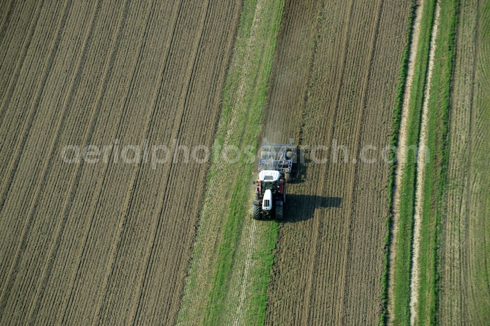 Laußig from above - Harvest use of heavy agricultural machinery - combine harvesters and harvesting vehicles on agricultural fields in Laussig in the state Saxony