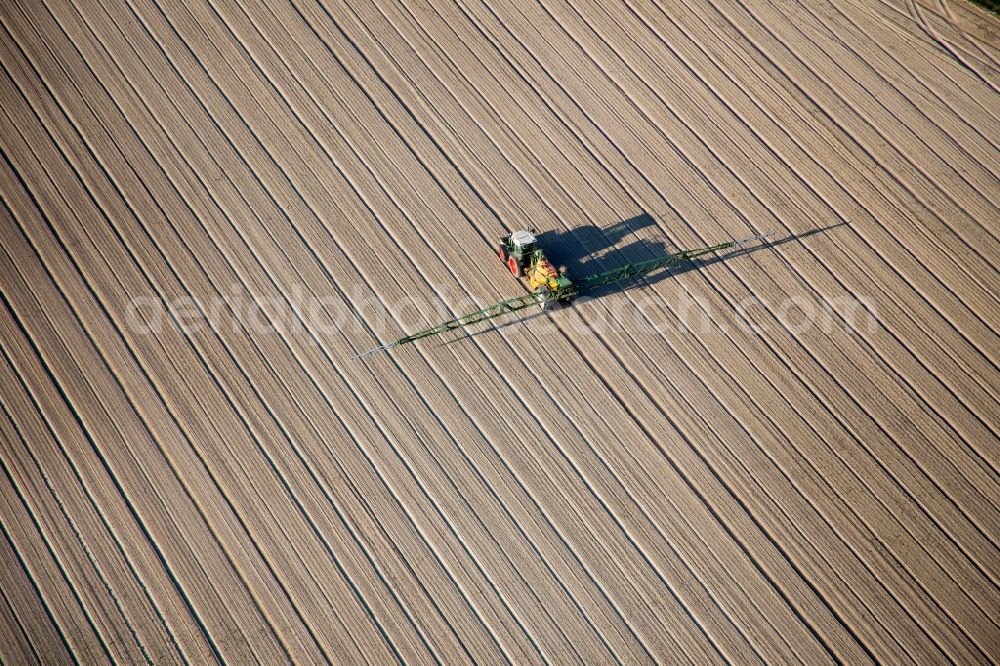 Alsheim from above - Tractor with spray device on agricultural fields in Alsheim in the state Rhineland-Palatinate