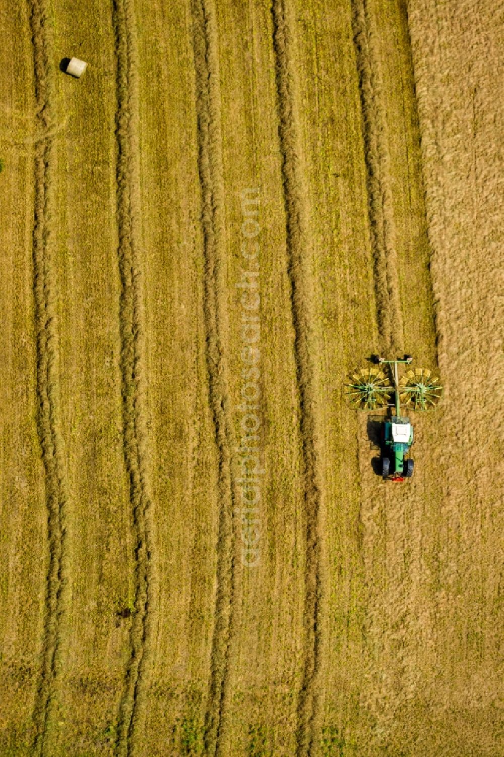 Aerial image Sprockhövel - Tractor with straw collectors and cereal straw rows on a harvested field to the grain harvest in Sprockhoevel in North Rhine-Westphalia