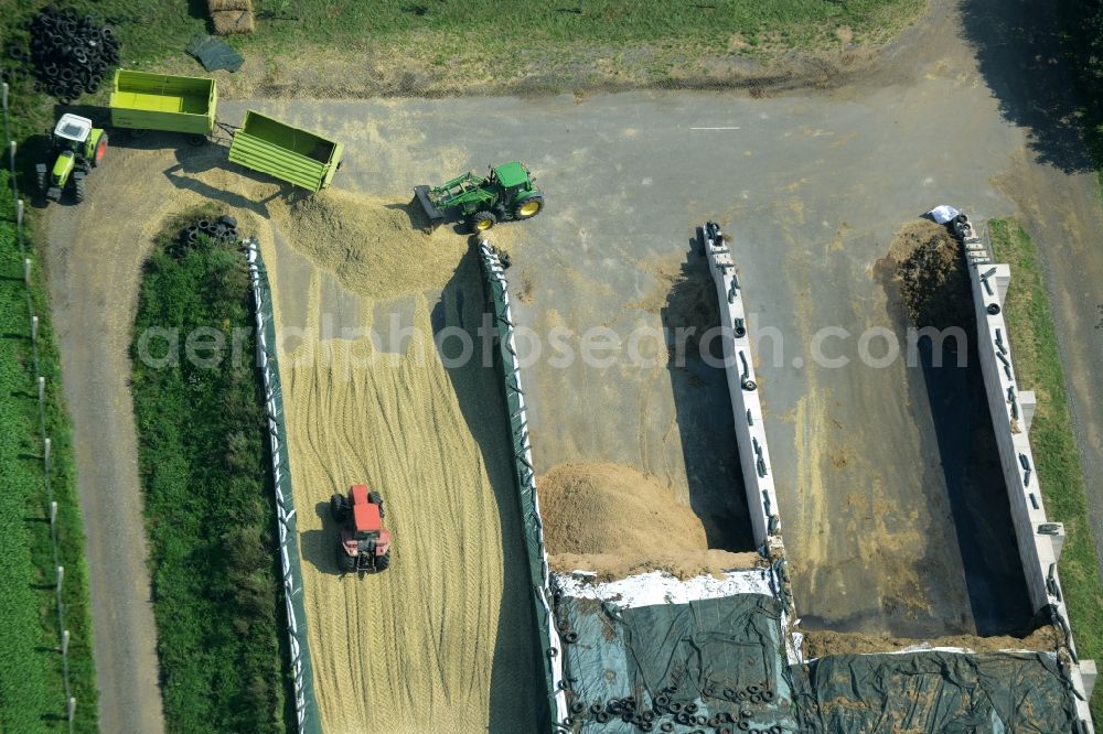 Zschepplin from the bird's eye view: Tractors on a farm and agricultural estate on the edge of Zschepplin in the state of Saxony. The compound with its halls and agricultural facilities is located in the North of the borough