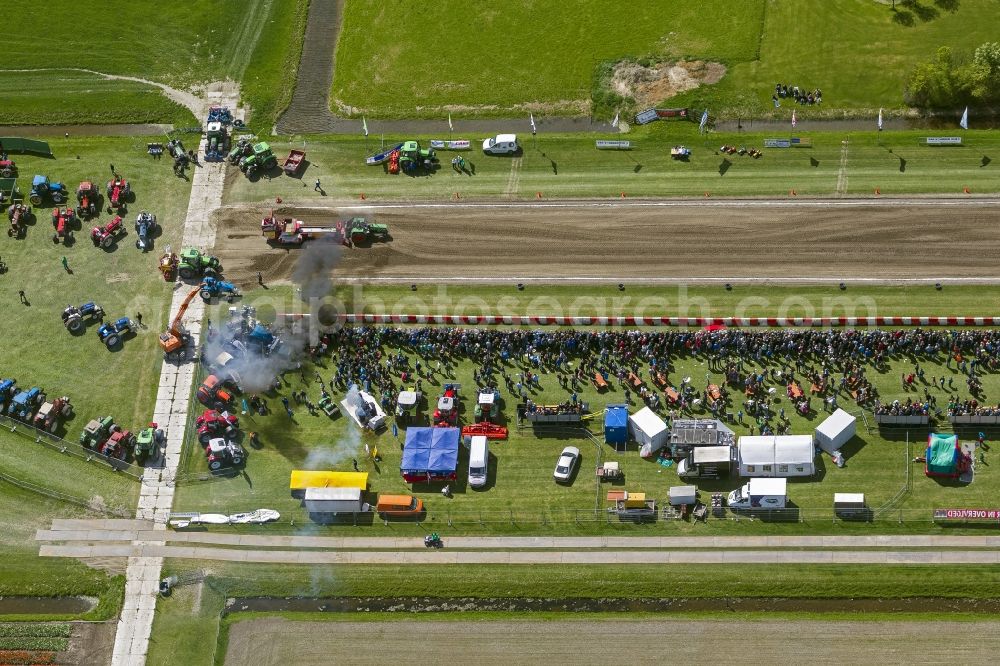 Hensbroek from the bird's eye view: Tractor pulling hard in Hensbroek in North Holland Holland / Netherlands