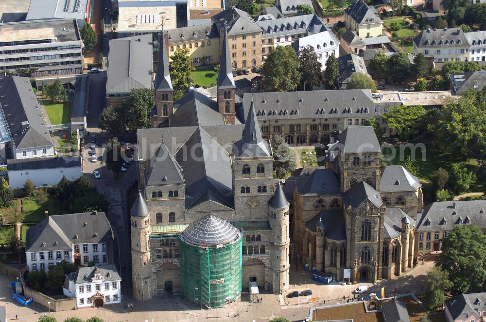 Aerial image TRIER - Trierer Dom, St. Gangolf und die Liebfrauenkirche in Trier. Die Hohe Domkirche St. Peter zu Trier ist die älteste Bischofskirche Deutschlands und die Mutterkirche des Bistums Trier. Das bedeutende sakrale Bauwerk abendländischer Baukunst steht seit 1986 zusammen mit der unmittelbar benachbarten Liebfrauenkirche auf der UNESCO-Liste des Weltkulturerbes. Mit einer Länge von 112,5 Metern und einer Breite von 41 Metern ist der Dom das größte Kirchengebäude der Stadt Trier.Der Dom steht über den Resten eines prächtigen römischen Wohnhauses. Nach dem Übertritt des römischen Kaisers Konstantin zum Christentum wurde eine Basilika errichtet, die unter Bischof Maximin (329–346) zu einer der größten Kirchenanlagen Europas mit vier Basiliken, einem Baptisterium und Nebengebäuden erweitert wurde.