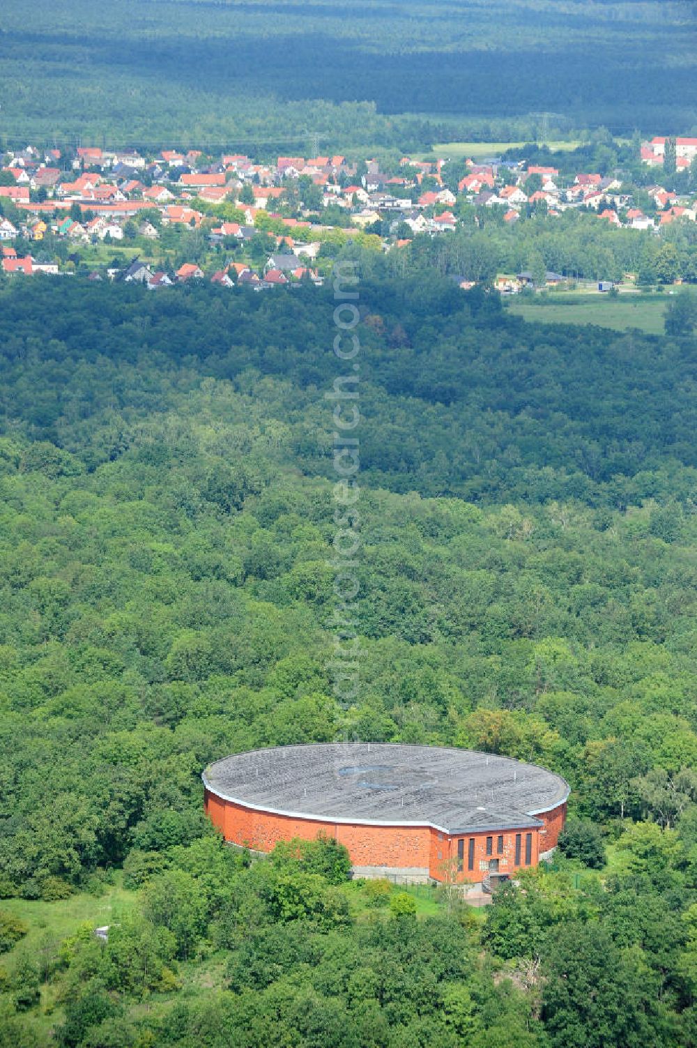 Aerial image Muldenstein - The red-clad high-water tank Muldenstein. Serving in GDR times on the Steinberg built storage for drinking water. Inside, there are two water chambers with a total of 8,000 cubic meters of drinking water