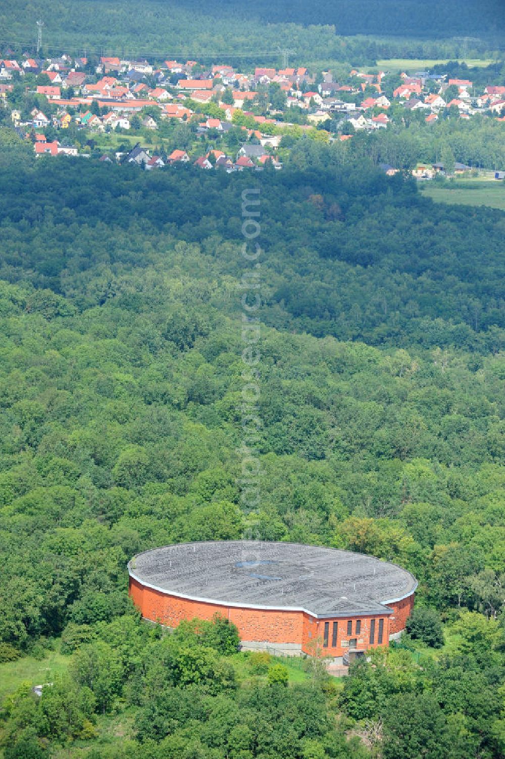 Aerial photograph Muldenstein - The red-clad high-water tank Muldenstein. Serving in GDR times on the Steinberg built storage for drinking water. Inside, there are two water chambers with a total of 8,000 cubic meters of drinking water