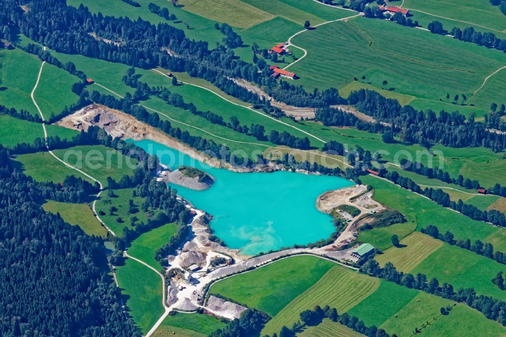 Aerial image Langgries - Turquoise water surface of Kilian Willibald gravel pit in Lenggries in the state Bavaria, Germany. The open pit area of a??a??the gravel quarry and gravel plant is located in the Isar valley
