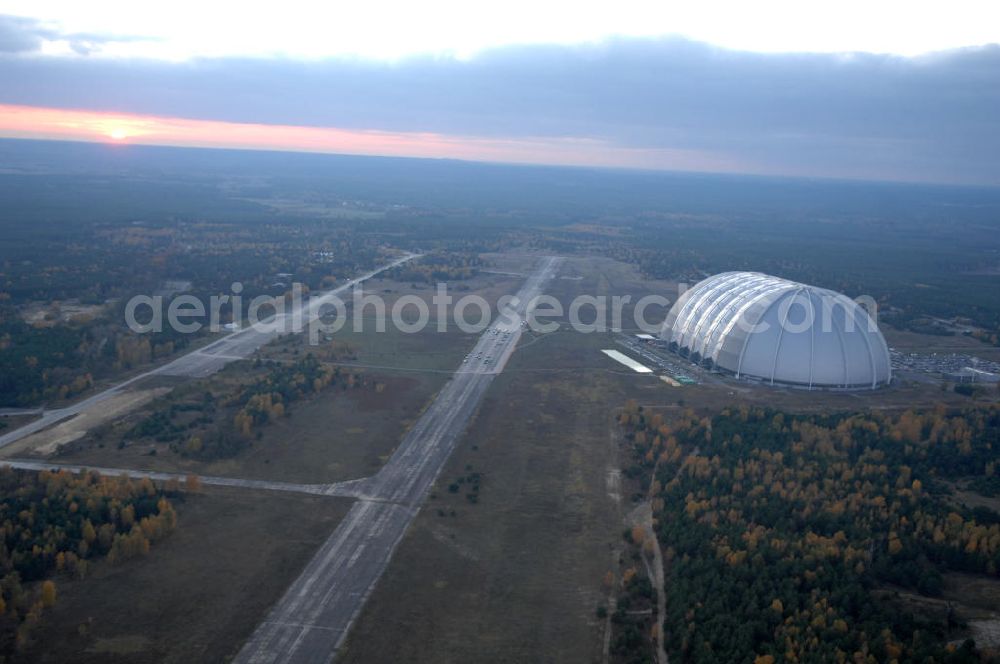 Aerial photograph Krausnick - Blick auf das Tropical Islands Resort in der Nähe von Krausnick in Brandenburg. Dieses Resort im Licht des Sonnenuntergangs ist ein als künstliche Tropenlandschaft angelegter Freizeitpark in der größten freitragenden Halle der Welt, 60 km südlich von Berlin. Postanschrift: Tropical Island Management GmbH, Tropical-Islands-Allee 1, 15910 Krausnick, Tel. (+49) 03 54 77 - 60 50 50,