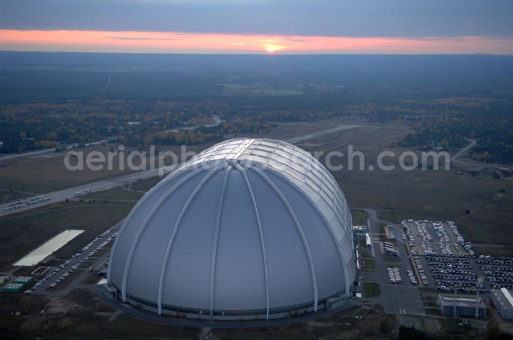 Aerial photograph Krausnick - Blick auf das Tropical Islands Resort in der Nähe von Krausnick in Brandenburg. Dieses Resort im Licht des Sonnenuntergangs ist ein als künstliche Tropenlandschaft angelegter Freizeitpark in der größten freitragenden Halle der Welt, 60 km südlich von Berlin. Postanschrift: Tropical Island Management GmbH, Tropical-Islands-Allee 1, 15910 Krausnick, Tel. (+49) 03 54 77 - 60 50 50,