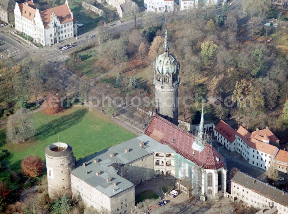 Aerial photograph Lutherstadt Wittenberg - Castle church of Wittenberg. The castle with its 88 m high Gothic tower at the west end of the town is a UNESCO World Heritage Site. It gained fame as the Wittenberg Augustinian monk and theology professor Martin Luther spread his disputation