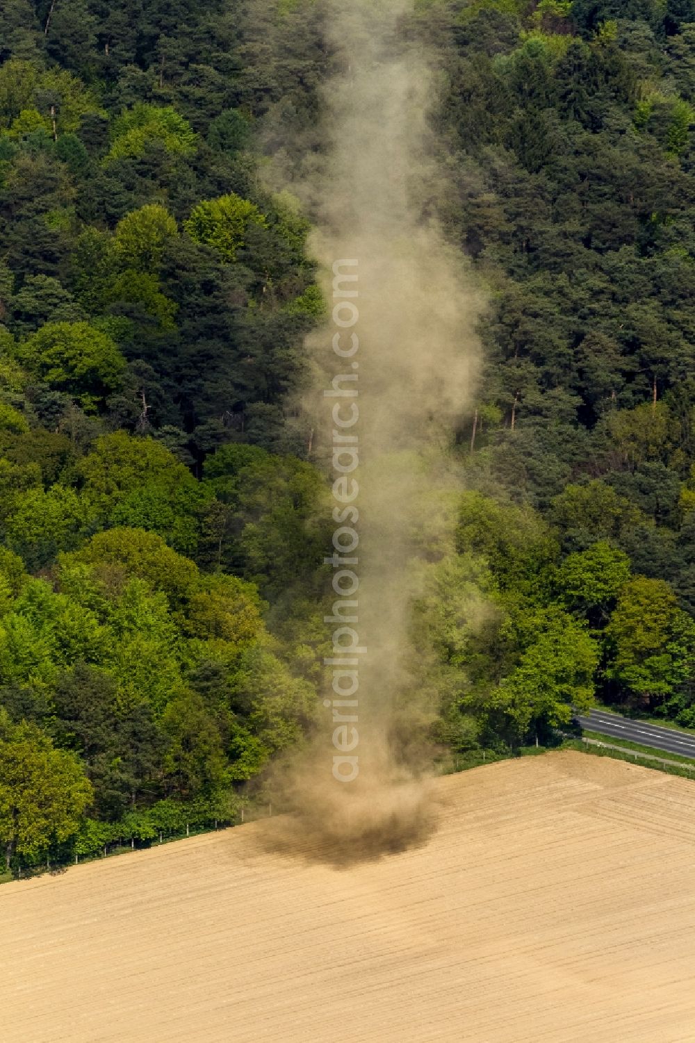 Aerial photograph Mönchengladbach - A tower-type hose of a high sand swirling wind rose on a field near Moenchengladbach in North Rhine-Westphalia