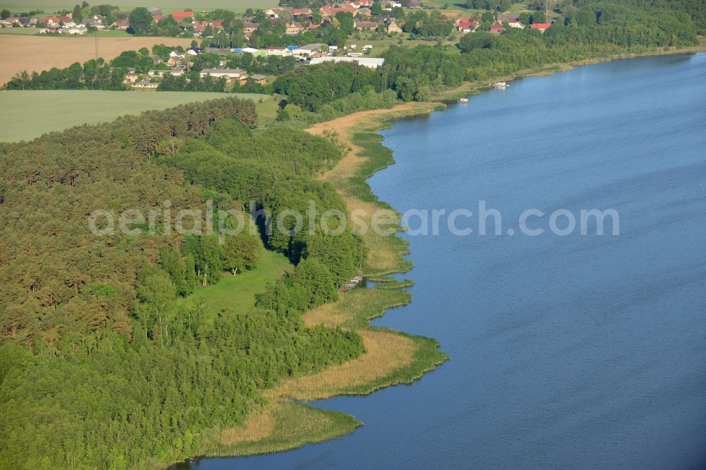 Löwenberger Land from above - Shores of Dreetzsee lake in the borough of Loewenberger Land in the state of Brandenburg. The lake is surrounded by trees and forest, the next village is the Grueneberg part of the borough. The background shows the Teschendorf part