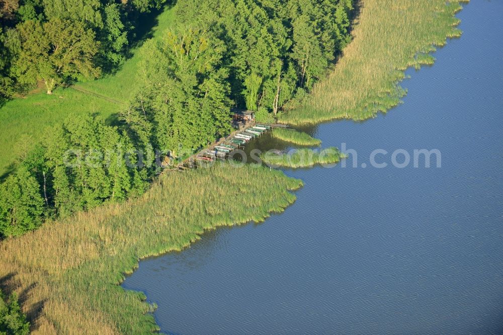 Löwenberger Land from above - Shores of Dreetzsee lake in the borough of Loewenberger Land in the state of Brandenburg. The lake is surrounded by trees and forest, the next village is the Grueneberg part of the borough. A small boat dock is located on its shore