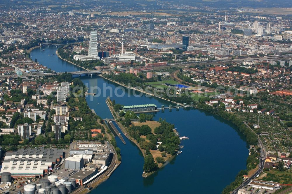 Birsfelden from the bird's eye view: Rhine river course with port area, lock, hydro powerplant and Island in Birsfelden in the canton Basel-Landschaft, Switzerland. Looking into the city area of Basel with ist skyscrapers