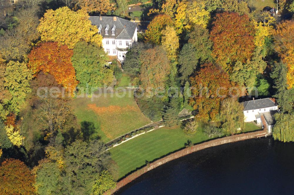 Aerial photograph Berlin - Blick auf den uferbereich an der Villa Siemens Am Kleinen Wannsee direkt gegenüber des Neubaus zum Immanuel-Krankenhauses in Berlin-Wannsee. Das Krankenhaus gehört zur Immanuel Diakonie Group (IDG), die eine Einrichtung der Evangelisch-Freikirchlichen Gemeinde Berlin-Schöneberg ist. Die Verwaltung der IDG hatte ihren Sitz in der Villa Siemens. Das Gebäude war einst eine Sommerresidenz von Arnold von Siemens, dem ältesten Sohn des Firmengründers Werner von Siemens. Die Architekten waren Paul und Walther Hentschel, 1888 wurde der Bau fertiggestellt. Die Villa Siemens gehörte zur Colonie Alsen, einer Siedlung für das Berliner Großbürgertum, die Wilhelm Conrad 1863 gegründet hatte. Nach dem Zweiten Weltkrieg stifteten Hermann und Charlotte von Siemens die Villa der Baptisten-Gemeinde mit der Auflage, sie für soziale Zwecke zu nutzen. Es ist das einzige Ensemble von Gebäude und Park der ehemaligen Kolonie, das bis heute erhalten geblieben ist. Der Krankenhausbetrieb ist jetzt in einem Neubau auf der gegenüberliegenden Straßenseite untergebracht. Das ehemals zum Areal gehörende Anwesen Am kleinen Wannsee Nr 4 wurde verkauft. ISA Immobilien Service Agentur GmbH, Herr Roland Kober