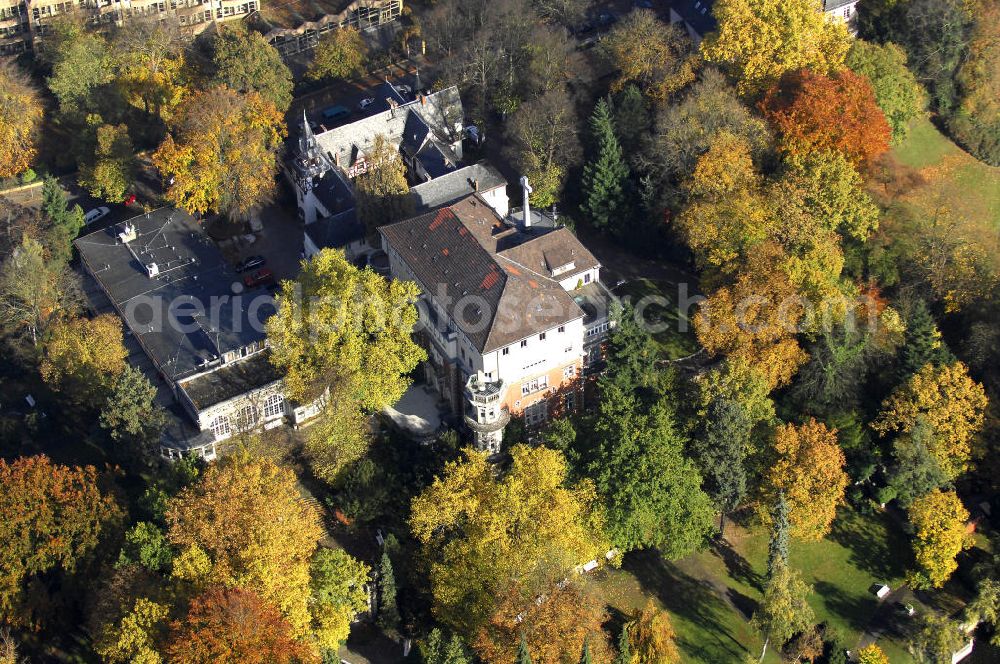 Aerial image Berlin - Blick auf den uferbereich an der Villa Siemens Am Kleinen Wannsee direkt gegenüber des Neubaus zum Immanuel-Krankenhauses in Berlin-Wannsee. Das Krankenhaus gehört zur Immanuel Diakonie Group (IDG), die eine Einrichtung der Evangelisch-Freikirchlichen Gemeinde Berlin-Schöneberg ist. Die Verwaltung der IDG hatte ihren Sitz in der Villa Siemens. Das Gebäude war einst eine Sommerresidenz von Arnold von Siemens, dem ältesten Sohn des Firmengründers Werner von Siemens. Die Architekten waren Paul und Walther Hentschel, 1888 wurde der Bau fertiggestellt. Die Villa Siemens gehörte zur Colonie Alsen, einer Siedlung für das Berliner Großbürgertum, die Wilhelm Conrad 1863 gegründet hatte. Nach dem Zweiten Weltkrieg stifteten Hermann und Charlotte von Siemens die Villa der Baptisten-Gemeinde mit der Auflage, sie für soziale Zwecke zu nutzen. Es ist das einzige Ensemble von Gebäude und Park der ehemaligen Kolonie, das bis heute erhalten geblieben ist. Der Krankenhausbetrieb ist jetzt in einem Neubau auf der gegenüberliegenden Straßenseite untergebracht. Das ehemals zum Areal gehörende Anwesen Am kleinen Wannsee Nr 4 wurde verkauft. ISA Immobilien Service Agentur GmbH, Herr Roland Kober