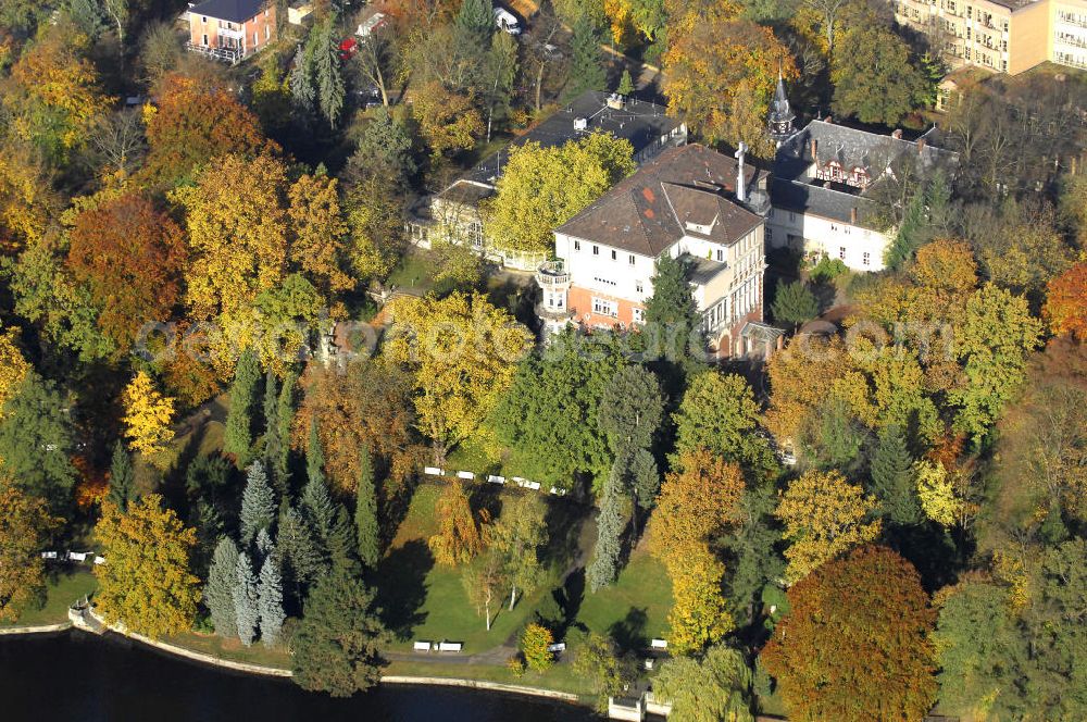 Berlin from the bird's eye view: Blick auf den uferbereich an der Villa Siemens Am Kleinen Wannsee direkt gegenüber des Neubaus zum Immanuel-Krankenhauses in Berlin-Wannsee. Das Krankenhaus gehört zur Immanuel Diakonie Group (IDG), die eine Einrichtung der Evangelisch-Freikirchlichen Gemeinde Berlin-Schöneberg ist. Die Verwaltung der IDG hatte ihren Sitz in der Villa Siemens. Das Gebäude war einst eine Sommerresidenz von Arnold von Siemens, dem ältesten Sohn des Firmengründers Werner von Siemens. Die Architekten waren Paul und Walther Hentschel, 1888 wurde der Bau fertiggestellt. Die Villa Siemens gehörte zur Colonie Alsen, einer Siedlung für das Berliner Großbürgertum, die Wilhelm Conrad 1863 gegründet hatte. Nach dem Zweiten Weltkrieg stifteten Hermann und Charlotte von Siemens die Villa der Baptisten-Gemeinde mit der Auflage, sie für soziale Zwecke zu nutzen. Es ist das einzige Ensemble von Gebäude und Park der ehemaligen Kolonie, das bis heute erhalten geblieben ist. Der Krankenhausbetrieb ist jetzt in einem Neubau auf der gegenüberliegenden Straßenseite untergebracht. Das ehemals zum Areal gehörende Anwesen Am kleinen Wannsee Nr 4 wurde verkauft. ISA Immobilien Service Agentur GmbH, Herr Roland Kober