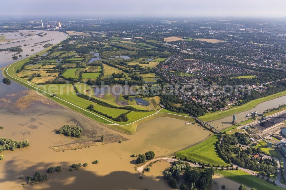 Duisburg from above - Shore areas with flooded by flood level riverbed of the Rhine river at the bridge Koenigstrasse in Walsum in the state North Rhine-Westphalia, Germany