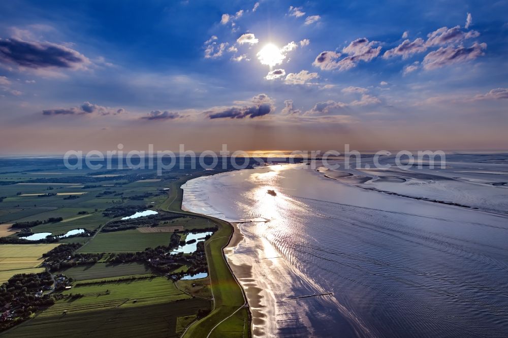 Cuxhaven from above - Riparian areas along the river mouth of the Elbe into the North Sea in sunset in Cuxhaven in the state of Lower Saxony. Shipping traffic on the North Sea and in the Elbe estuary, arriving, heading east