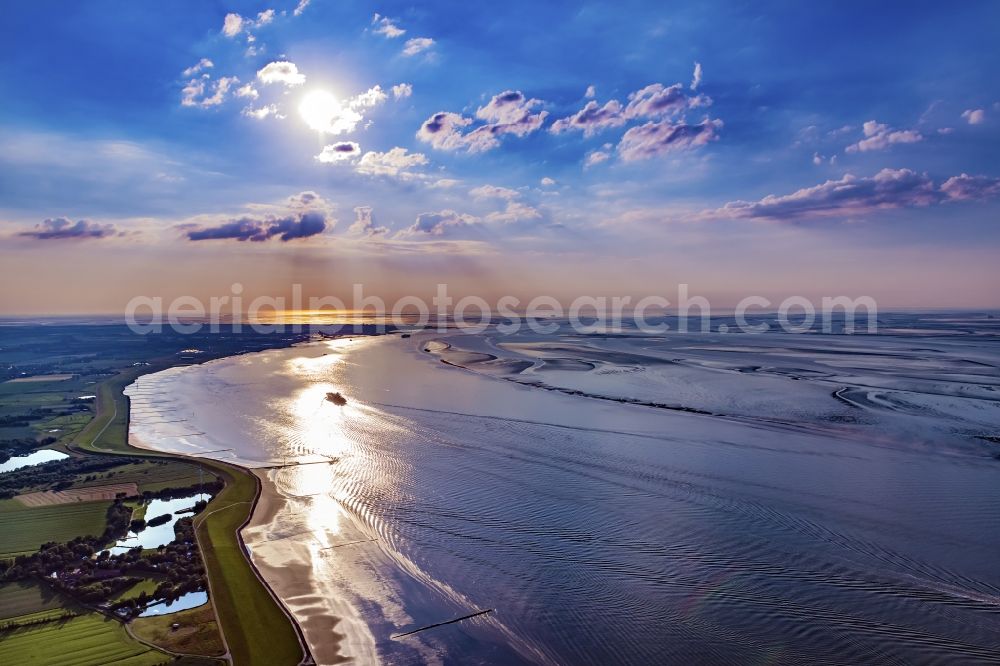 Cuxhaven from the bird's eye view: Riparian areas along the river mouth of the Elbe into the North Sea in sunset in Cuxhaven in the state of Lower Saxony. Shipping traffic on the North Sea and in the Elbe estuary, arriving, heading east