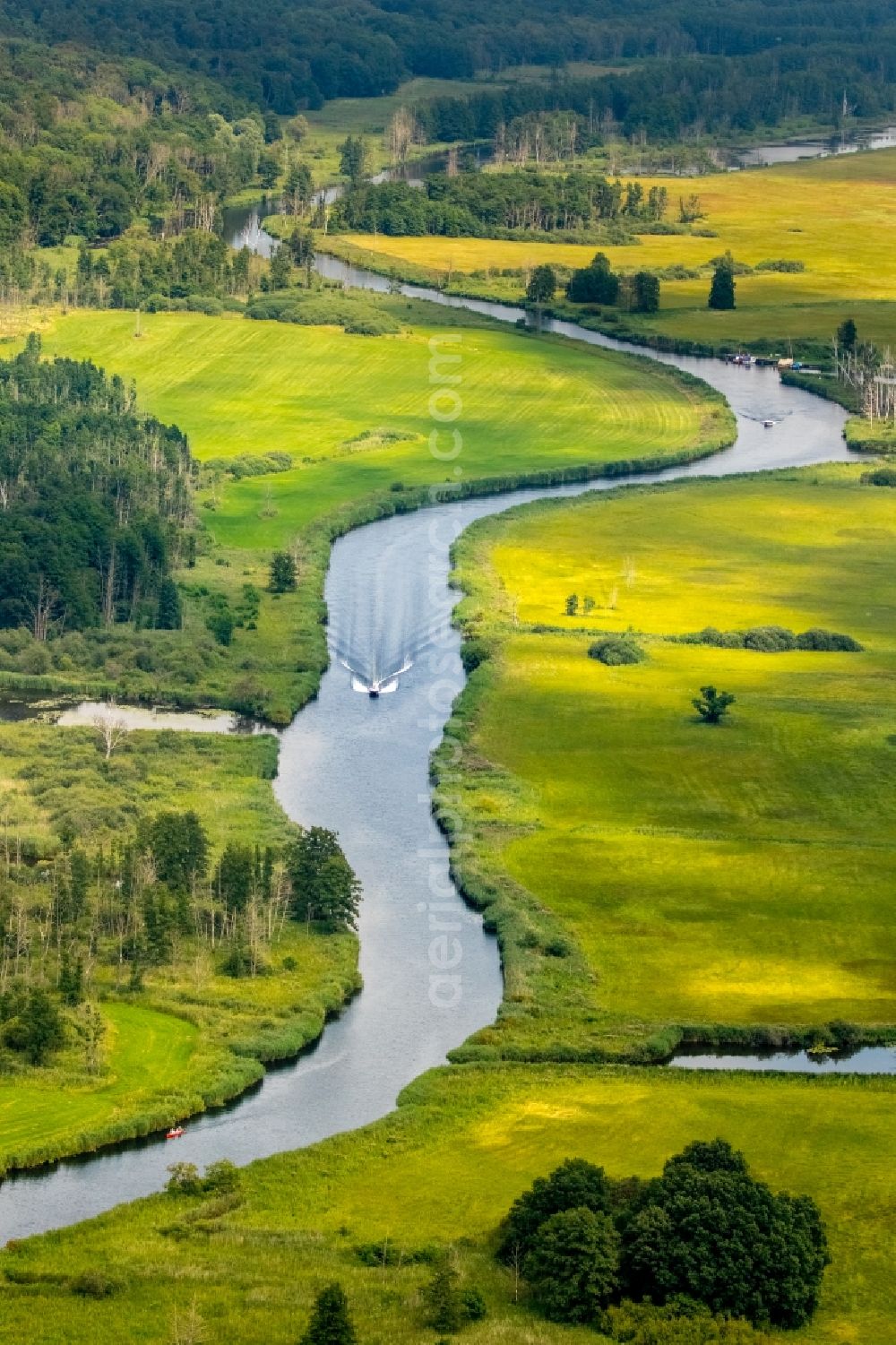 Warrenzin from above - Riparian zones on the course of the river Peene and motorboat in Warrenzin in the state Mecklenburg - Western Pomerania