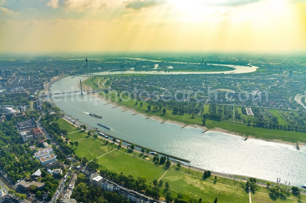 Düsseldorf from the bird's eye view: Riparian zones on the course of the river of Rhein on Oberkasseler Bruecke in Duesseldorf in the state North Rhine-Westphalia, Germany